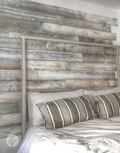 a white bed with wooden headboard and pillows