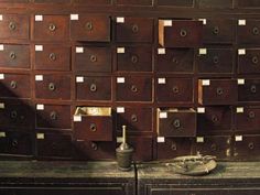 many drawers are stacked on top of each other in an old room with one drawer open