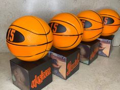 three orange basketballs sitting on top of boxes