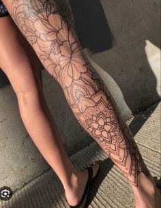 a woman's leg with flowers on it