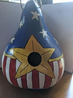 a vase with an american flag design painted on it's side, sitting on a table