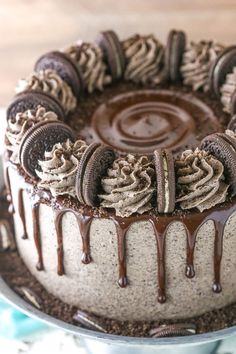 an oreo cookies and cream cake with chocolate drizzles on the top