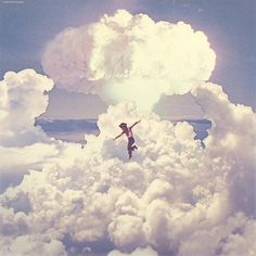 a woman is flying through the clouds with her arms outstretched