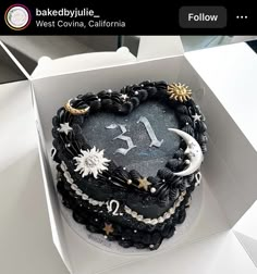 a heart shaped cake in a box with stars and moon decorations on it's side