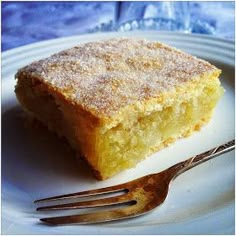 a piece of cake sitting on top of a white plate with a fork next to it