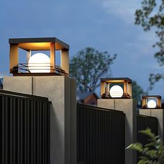 three lights on top of a building with trees in the background