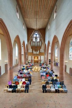 the inside of a large church with rows of tables and chairs in front of them