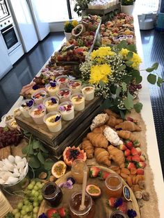 a buffet table filled with lots of different foods and desserts on top of it