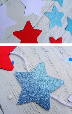 red, white and blue stars are hanging from string on the table with confetti