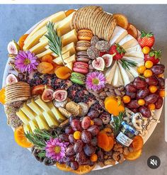 a platter filled with different types of cheeses and crackers