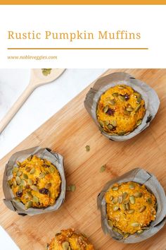 three muffins with pumpkin and seeds in them on a cutting board