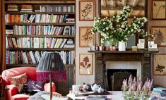 a living room filled with lots of books and furniture