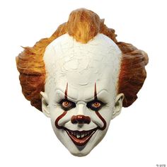 a creepy clown mask with red hair and orange eyes