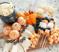 an assortment of halloween treats on a wooden board