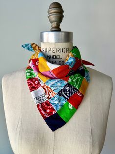 a white mannequin wearing a multicolored scarf on it's neck