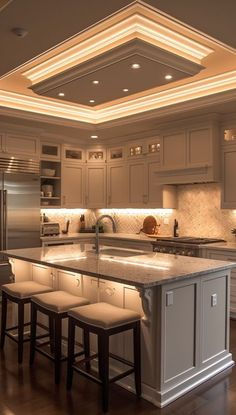 a large kitchen with an island in the middle and stools at the counter top