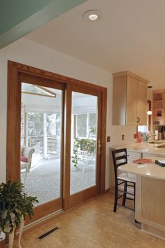 an open kitchen and dining room with sliding glass doors