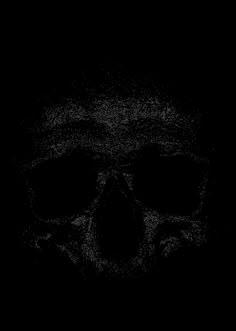 a black and white photo of a skull in the dark