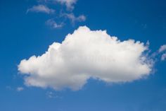 a white cloud floating in the sky on a sunny day royalty images and stock photos