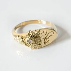 This vintage-inspired floral ring is a row of dainty flowers wrapped around your fingers. Handmade and polished, it is available in solid 8K and 14K gold. This item is engravable with text or monogram of your choice at no extra cost. The initals are engraved onto the ring and embedded in the 3D model for a flawless embossed finish. It is also possible to add a diamond or birthstone or diamond to this ring at an additional fee. Please inquire for details. A few notes about our gold:- Though we do Ladies Signet Ring, Heirloom Birth Flower Jewelry, Heirloom 14k Gold Flower Ring With Rose Cut Diamonds, Classic Round Birth Flower Jewelry, Heirloom Flower Ring With Rose Cut Diamonds As Gift, Classic White Gold Flower Ring With Rose Cut Diamonds, Heirloom Rose Cut Diamond Flower Ring As Gift, Delicate Yellow Gold Engraved Ring For Anniversary, Anniversary Jewelry With Rose Cut Diamonds In Flower Shape