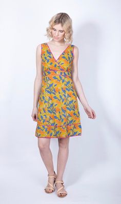 "This beautiful short cotton sun dress is perfect for your summer wardrobe. The marigold yellow and blue floral print on natural block print fabric is both eye-catching and versatile. The dress features a flattering v-neckline and sleeveless design, with a hidden side zip for easy wear. The fitted waist creates a feminine silhouette, while the sweetheart neckline and cap sleeves add a touch of elegance. Perfect for a summer day out or a casual garden party, this dress is both beautiful and comfortable. Small : UK size 6-8 Bust 32\"/41cm Waist 32\"/81cm Hips 34\"/86cmcm  Length 37\"/94cm Medium Uk  10 -12 Bust 34\"/86cm Waist 34\".86cm Hips 36\"/91cm Length 38\"/97cm Large UK  14 -16 Bust 36\"/86cm Waist 36\"/81cm Hips 38\"/97cm Length 39\"/99cm XL  UK 16 -18 Bust 38\"/97cm Waist 38\"/86cm V-neck Cotton Sundress For Vacation, Sleeveless Printed Cotton Sundress, Yellow V-neck Sundress For Summer, Yellow Cotton Bohemian Sundress, Sleeveless Lemon Print Sundress For Vacation, Cotton Lemon Print Dress For Vacation, Summer Cotton Dresses With Lemon Print, Summer Cotton Dress With Lemon Print, Yellow Cotton Sundress For Spring