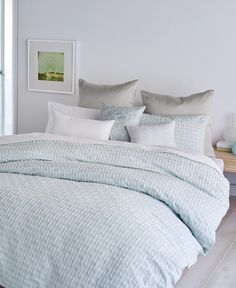 a bed with blue and white comforters in a bedroom