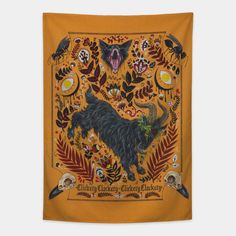 a tapestry hanging on the wall with an image of a horned animal surrounded by leaves and flowers