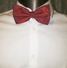 Claret red silk bow tie by Austin Reed. Adjustable length. Elegant Red Bow For Gift, Dapper Red Suit And Tie Accessories For Formal Events, Dapper Red Suit And Tie Accessories For Formal Occasions, Elegant Red Satin Bow, Red Bow Tie For Party, Red Bow Standard Bow Tie For Party, Red Bow With Butterfly Knot For Party, Elegant Red Bow With Butterfly Knot, Elegant Red Adjustable Bow