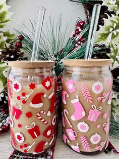 two decorated mason jars sitting next to each other