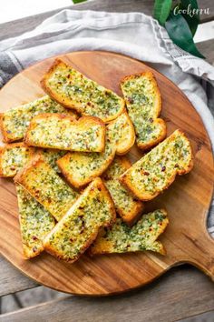 garlic bread with pesto on a wooden plate