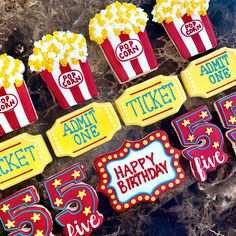 birthday cupcakes with popcorn and movie tickets on them