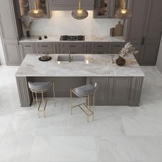 a kitchen with marble counter tops and gray cabinets