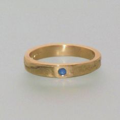 This ring is our popular 4 mm, 14 kt yellow gold casting ring. However, this particular ring features a 1.0.31 inch, 8 mm sapphire gemstone. Upon request, the ring can also be crafted with rose-colored or white gold. The shown price refers to a ring with a size of 48. Different prices can be shown by selecting the appropriate ring size. For example, a pair of rings with sizes of 52 and 59 would cost around For men, the ring can be ordered without the gemstone. You can also choose to include a na Gold Sapphire Birthstone Ring For Promise, Gold Sapphire Ring With Bezel Setting And Round Band, Yellow Gold Sapphire Ring With Tension Setting, Yellow Gold Sapphire Ring With Round Band, Gold Sapphire Stackable Promise Rings, Gold Sapphire Stackable Rings For Promise, Gold Sapphire Rings With Tension Setting, Gold Sapphire Ring With Tension Setting For Promise, Classic Gold Stackable Sapphire Rings