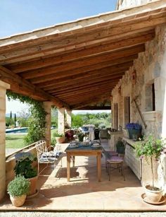 an outdoor covered patio with potted plants