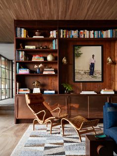 a living room filled with furniture and bookshelves next to a wall mounted tv