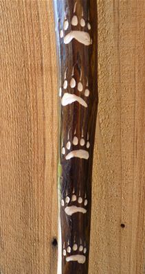 a wooden pole with white designs on it