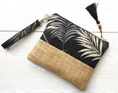 a black and white palm leaf purse with tassel