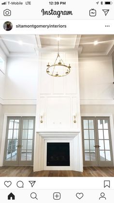 an instagram photo of a living room with white walls and wood flooring on the bottom level