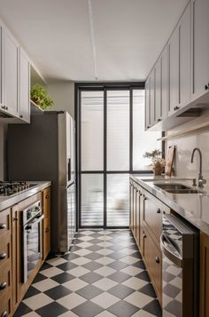 a kitchen with black and white checkered flooring