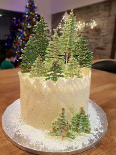 there is a cake decorated with trees on the table