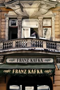 an old building with a sign that says cafe franz kafka