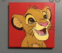 a painting of a smiling lion on a red background with the word disney written below it