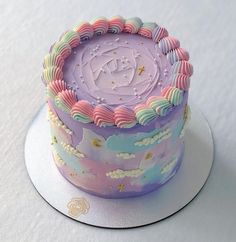 there is a purple cake with clouds and stars on it