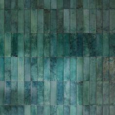 a green tiled wall with lots of different colors