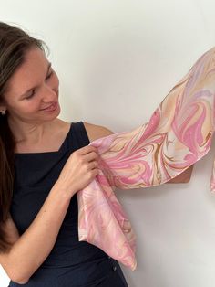 "Perfect gift for holidays and personal events, but great for adding a splash of fantasy in daily use. 100% handmade in Jerusalem silk scarf in soft&cozy pink pastels in a marbled pattern. Hand wash only.  The one-of -a-kind marbling pattern is made by floating pigments over a natural fluid and printing the design onto the silk. The ancient art of Marbling started in the Far East ca. 1,000 years ago as part of the poetry and calligraphy pursuit of the courts.  It was carried over the Silk Road t Artistic Pink Silk Scarf, Pink Hand-dyed Scarf, Handmade Pink Silk Scarf, Handmade Pink Silk Scarves, Pink Artistic Scarf Gift, Marbling Pattern, Purple Gothic, Gothic Pattern, The Silk Road