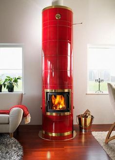 a living room filled with furniture and a fire place in the middle of the room