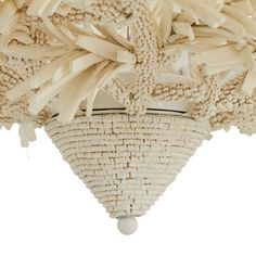 a white basket hanging from the ceiling with many pieces of woven on top of it