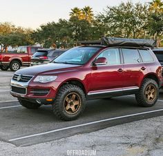 a red suv parked in a parking lot