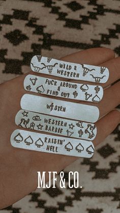 four hand stamped labels in the palm of someone's hand