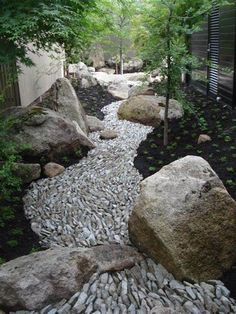 a garden with rocks and trees in it